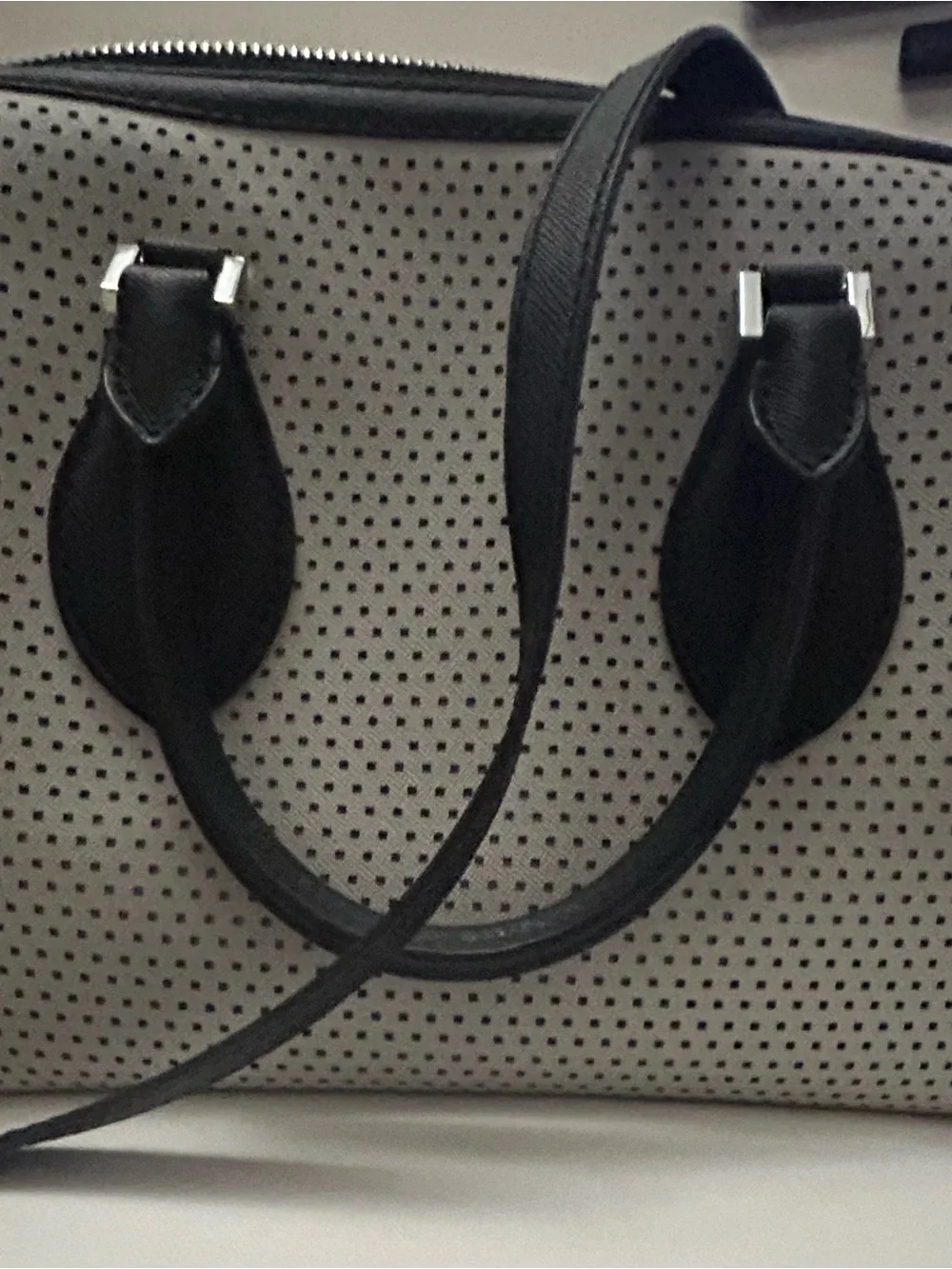 Michael Kors White Perforated Satchel with Black Trim and matching black wallet.